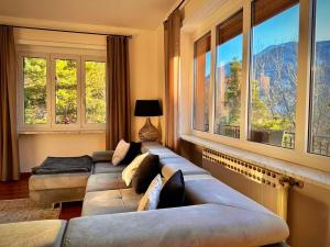 a living room with two couches and large windows at Luxury 3 bedroom Grand Chalet in Perosa Argentina