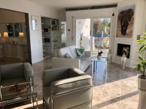 a living room with a couch and chairs and a table at Casa Bellavista Rovio in Rovio