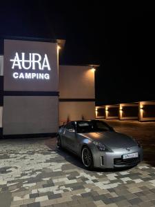 a silver car parked in front of a building at AURA camping in Zhezdi