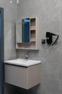 a bathroom with a sink and a mirror at AURA camping in Zhezdi