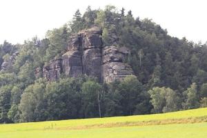 a large rock formation in the middle of a field at Villa Weißig in Struppen