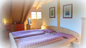 a bedroom with a large bed with purple pillows at Villa Weißig in Struppen +12 photos