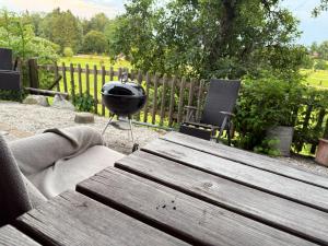 a grill sitting on top of a wooden picnic table at Schwaigerhof in Wackersberg +16 photos