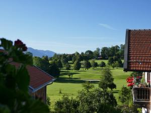 a view of a lush green golf course at Schwaigerhof in Wackersberg