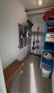 a room with a bench and a shelf and a ladder at Cèsa Emily in Campitello di Fassa