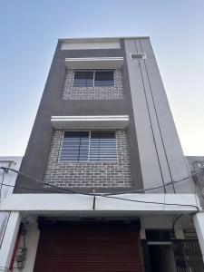 a tall building with barred windows on it at Maheshwari Homes in Ujjain