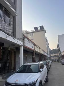 a row of cars parked in front of a building at Maheshwari Homes in Ujjain