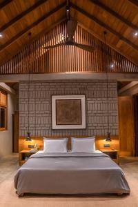 a bedroom with a large bed with two lamps at VeeRaa Retreat in Habarana +48 photos