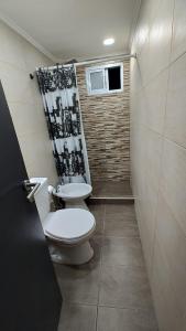 een kleine badkamer met een toilet en een raam bij Depto Roko in Villa Gesell