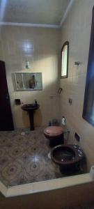 a bathroom with a toilet and a sink at Suíte da Virada in Guarujá