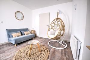 a living room with a couch and a mirror at les doux secrets de Bergère in Périgueux