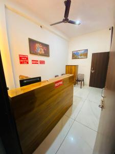 a law office with a wooden reception desk at Dh Hotel in Bhiwāni