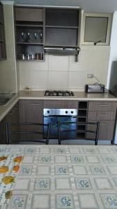 a kitchen with a stove and a counter top at Depto Condominio La Casona in El Quisco