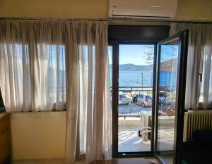 a room with a window with a view of the water at 2Steps to the Lake in Kastoria