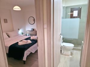 a bedroom with a bed and a bathroom with a toilet at 2Steps to the Lake in Kastoria +13 photos