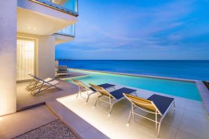 una casa con piscina e tavolo e sedie di Bedda Matri a Noto