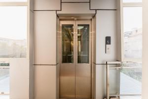 a elevator in a building with glass doors at Treebo Advantage Inn in Allahābād