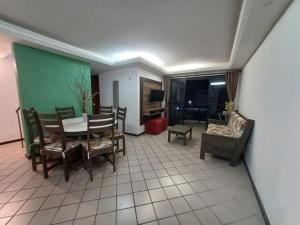 a living room with a dining room table and chairs at Apartamento Cobertura Praia Camboinha in Cabedelo