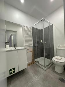 a bathroom with a shower and a toilet and a sink at DDM Studio - O paraíso do Sítio da Nazaré in Nazaré