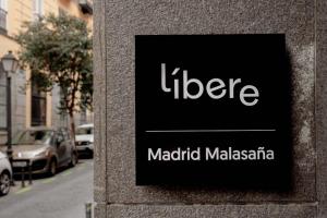 a sign on the side of a building at Líbere Madrid Malasaña in Madrid