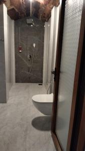 a bathroom with a shower and a bath tub at Sea Shades Palolem Resort in Palolem