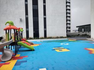 a playground with a slide in a building at Serenity Apartment Artesano in Nairobi