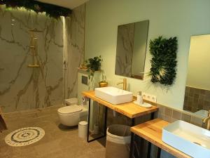a bathroom with a sink and a toilet and a mirror at La única in Coín