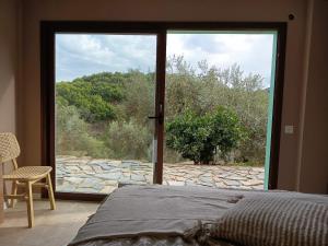 a bedroom with a bed and a large glass door at La única in Coín