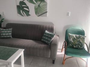 a living room with a couch and a chair at Peacehaven's Finest View 107 in Scottburgh