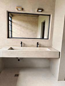 a bathroom with a white sink and a mirror at Om infinity - Pre opening in Tupungato