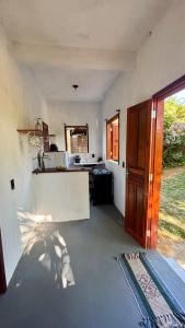 a view of a kitchen with a counter top at Taboca Chalé na Rua do Serrão in Cairu