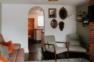a living room with two chairs and a couch at River Cottage in Beccles