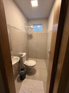 a bathroom with a toilet and a sink at Cerrado Hostel in Goiânia