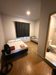 a bedroom with a bed and a bathroom with a shower at Cerrado Hostel in Goiânia +74 photos