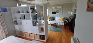 a living room with a white book shelf at Dunslair View Appartment in Peebles