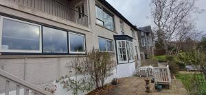 a house with large windows on the side of it at Dunslair View Appartment in Peebles