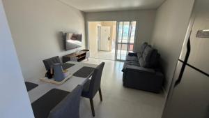 a living room with a couch and a table at Cód 2 - Cobertura de 2 dormitórios na Praia Grande in Rodeio