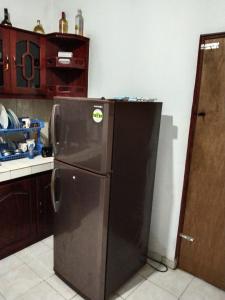 a kitchen with a black refrigerator in a kitchen at Lankadays in Negombo