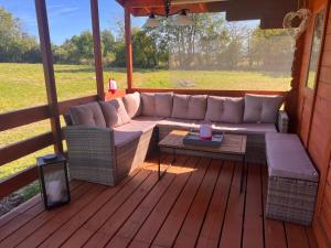 een veranda met een bank en een tafel op een terras bij Pond Cabin  +15 foto's