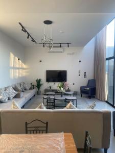 a living room with a couch and a tv at شاليهات ريف الوادي in Taif