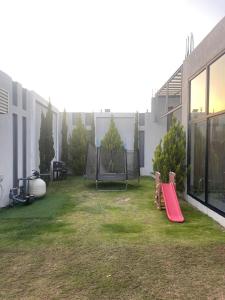 a small yard with a playground with a slide at شاليهات ريف الوادي in Taif