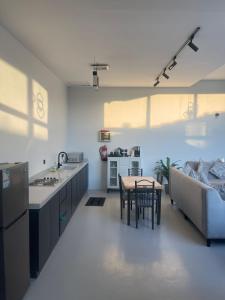 a kitchen and living room with a table and a couch at شاليهات ريف الوادي in Taif