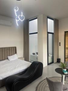 a bedroom with a large bed with a black chair at شاليهات ريف الوادي in Taif +33 photos
