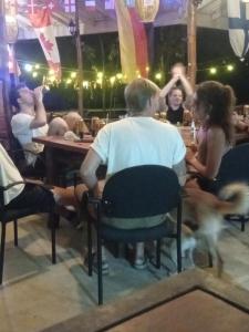 a group of people sitting at a table in a restaurant at One More Night Hostel in Sigiriya
