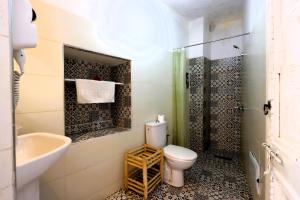 a bathroom with a toilet and a sink and a shower at Riad Makech in Marrakesh +63 photos