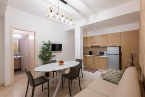 a living room and kitchen with a table and chairs at Residence Perla in Misano Adriatico