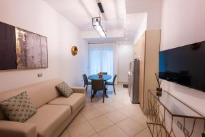 a living room with a couch and a table at Residence Perla in Misano Adriatico