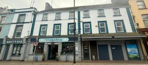a large white building on a city street at Tipperary Town House in Tipperary