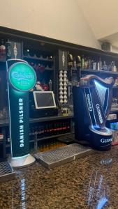 a counter in a store with a drink cooler at Tipperary Town House in Tipperary