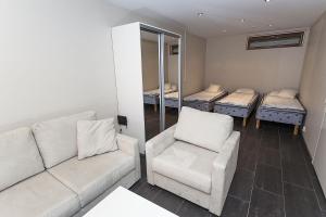 a living room with a couch and four mattresses at Cozy Alpine-Style Apartment in the Heart of Levi with Private Sauna & Fireplace in Levi +3 photos